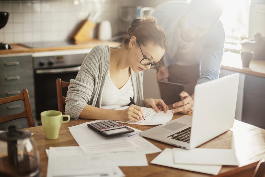 Photo of a young couple calculating home finances