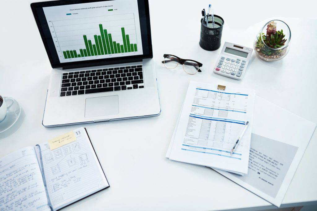 High angle shot of a desk with various items on it in a financial company