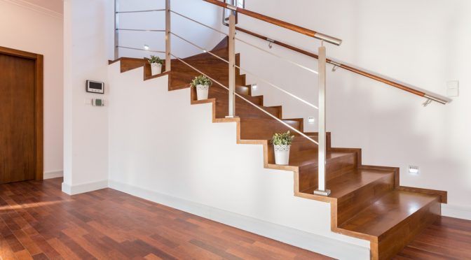 Flowerpots situated on wooden stairs