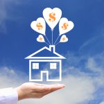 Female hands holding symbol of house with balloon and symbol of dollar on blue sky background, Save money for prepare in future and Banking concept