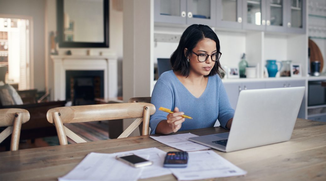 Shot of a young woman using a laptop while working from home