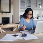 Shot of a young woman using a laptop while working from home