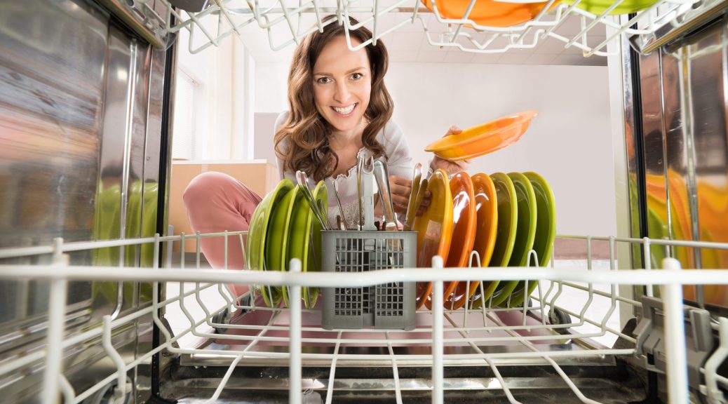 Happy Woman Removing Plate View From Inside The Dishwasher