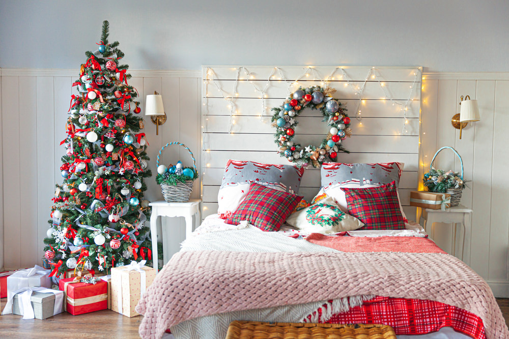 Classic interior room with Christmas tree and traditional white red decorations. Modern clean white classical style interior design apartment bedroom. Christmas eve at home. Minimalist home design