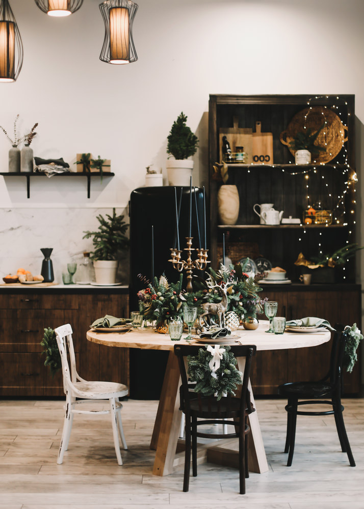 Festive kitchen in Christmas decorations. Christmas dining room. Beautiful New Year decorated classic home interior. New Year and Christmas background